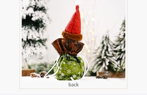 Detail of Christmas gnome drawstring gift bag with snowflake patterns and red knit cap