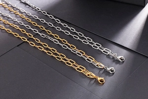 Detailed view of layered gold and silver paperclip link necklaces with lobster clasps