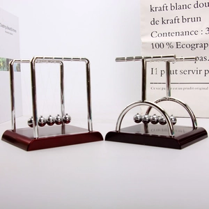 Newton's cradle with square and arc frames on mahogany base for desk decor