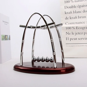 Close-up of polished silver Newton's cradle balance balls on a deep red base
