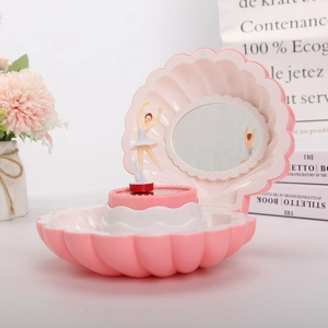 Detailed view of pink shell music box featuring a rotating ballerina and built-in mirror