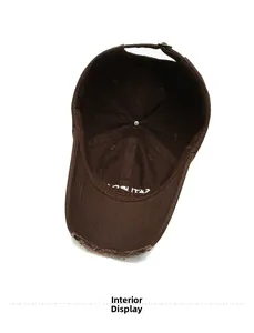 Detailed interior view of a distressed brown baseball cap with adjustable metal buckle strap