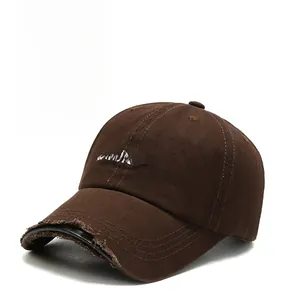 Detail of Saturday embroidery and distressed brim on a brown vintage baseball cap