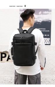 Rear view of a model wearing the waterproof black laptop backpack for travel
