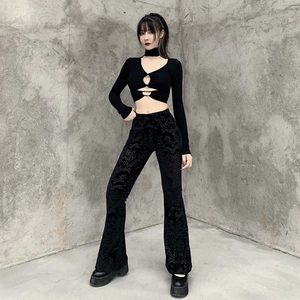 Detail of black flared trousers with embossed velvet fabric and a side hollow-out design
