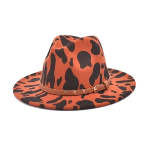 Detail of fedora hat felt material with cow print pattern and leather studded hatband