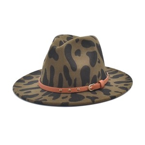 Close-up of leopard print fedora hat featuring a brown leather band and gold metal studs