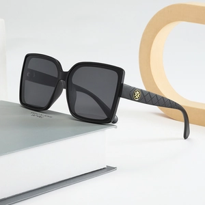 Classic black square sunglasses with quilted texture temples and golden floral emblem