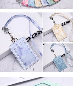 Close-up of marble pattern PU leather ID holders with retractable lanyards and clear windows