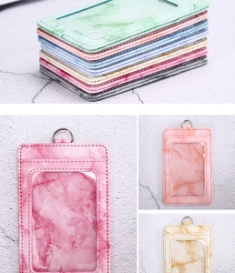 Detail of marble pattern PU leather ID card holders with clear windows and metal D-rings