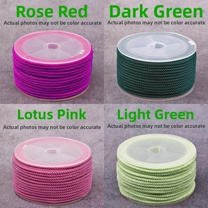 Detail view of 2mm pineapple cord in rose red, dark green, lotus pink, and light green rolls