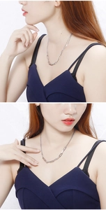 Silver paperclip link necklace on a model showing the chunky geometric layered design