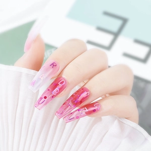 Pink purple gradient almond nails with holographic letters and glitter on fabric background