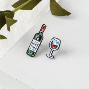 Cartoon enamel wine bottle and glass brooch set with 'WINE TIME' lettering on metal