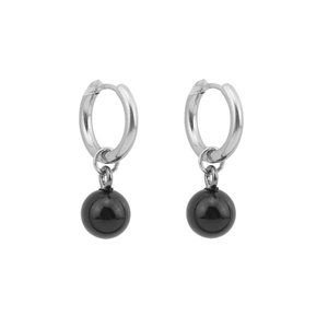 Detail of silver stainless steel hoop earrings featuring glossy black pearl pendants