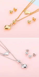 Detail of multi-layered gold and silver necklace sets with heart pendants on pink backdrop