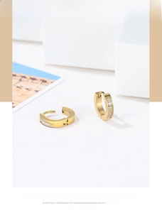Detailed view of gold hoop earrings featuring polished finish and sparkling cubic zirconia