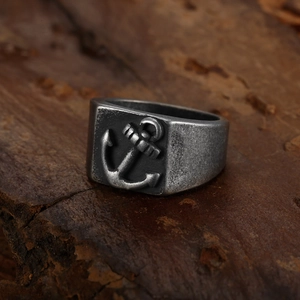 Vintage anchor seal ring in distressed silver stainless steel for men on wood base