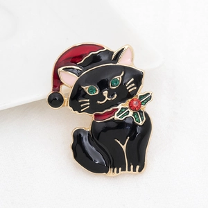 Close-up of black Christmas cat brooch with red hat and sparkling rhinestone details