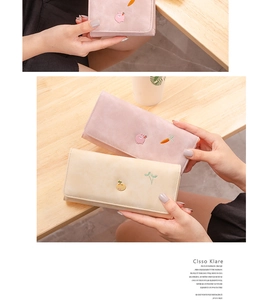 Detail of pink and white long wallet with cute pig and carrot cartoon embroidery
