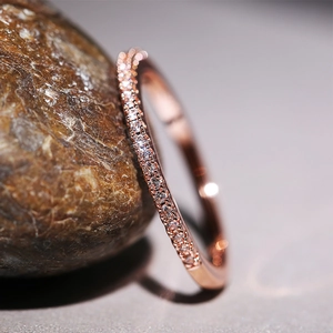 Minimalist rose gold ring featuring micro-paved cubic zirconia in a slim stackable style
