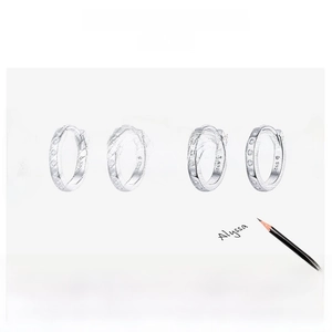 Macro shot of S925 sterling silver hoop earrings featuring brushed metal and cubic zirconia