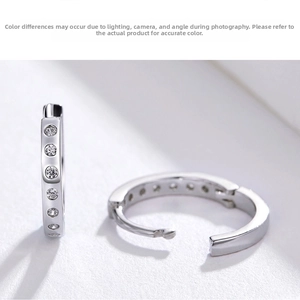 Macro shot of silver S925 hoop earrings with six inlaid cubic zirconia stones