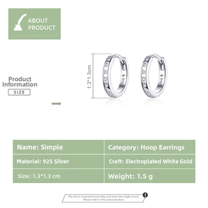 Detailed view of S925 sterling silver huggie earrings with cubic zirconia stones