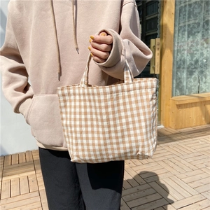 Close-up of khaki and cream checkered cotton linen tote bag with sturdy handles