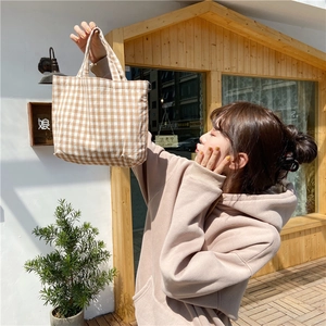 Close-up of yellow gingham canvas tote bag with textured cotton-linen fabric handle
