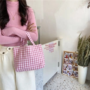 Detail shot of pink and white checkered cotton linen bento bag with durable handles