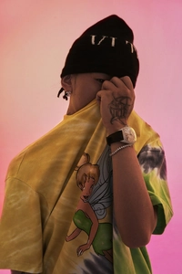 Detailed view of luxury iced-out hip-hop bracelet on model with colorful street wear