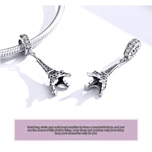 Macro shot of S925 silver Eiffel Tower charm with zircons on a snake chain bracelet