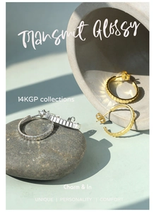 Detail showing the ribbed texture of the 14K gold-plated C-shaped hoop earrings