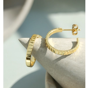 Golden hoop earrings with square texture design and polished metallic finish