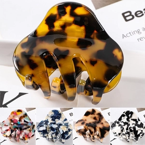 Detail showcasing variety of stylish tortoise shell and marble textured hair claw clips
