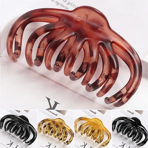 Detail view of large octopus claw hair clips in various tortoiseshell and solid finishes