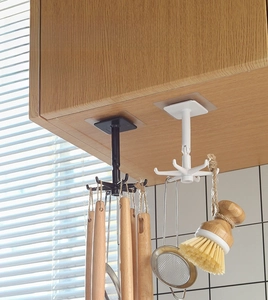 Close-up of 360-degree rotating six-claw kitchen hook installed under a cabinet