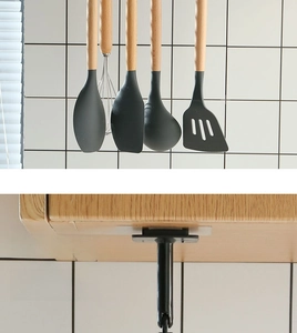Detail of adhesive rotating kitchen rack mounted under cabinet for utensil storage