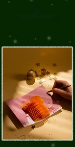 Close-up of 3D Christmas card with orange honeycomb paper structure and festive snowman