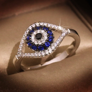Sparkling S925 sterling silver evil eye ring with blue and white crystals on silk base