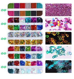 Macro detail of 12-grid nail glitter set featuring hearts, letters and snowflake shapes