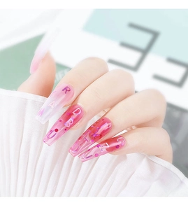 Detail of pink gradient coffin press-on nails with colorful 3D letter inserts for DIY art