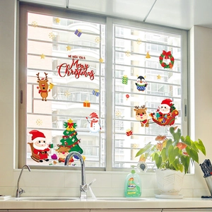 Christmas window stickers set with Santa, reindeer and snowman on a kitchen glass window