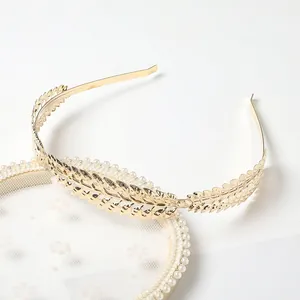 Detailed view of a golden laurel leaf headband with fine metallic leaf textures