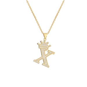 Macro shot of gold-plated crown letter X pendant necklace with sparkling cubic zirconia