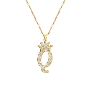 Close-up of gold plated crown letter Q pendant with shimmering micro-set zircons
