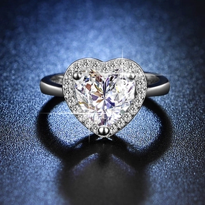Macro close-up of heart-shaped halo ring featuring sparkling simulated moissanite stone