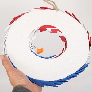 Patriotic eagle wreath with red, white, and blue feathers and hanging rope for door decor