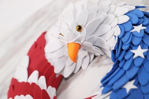 Close-up of patriotic eagle wreath with American flag star patterns and red white blue feathers